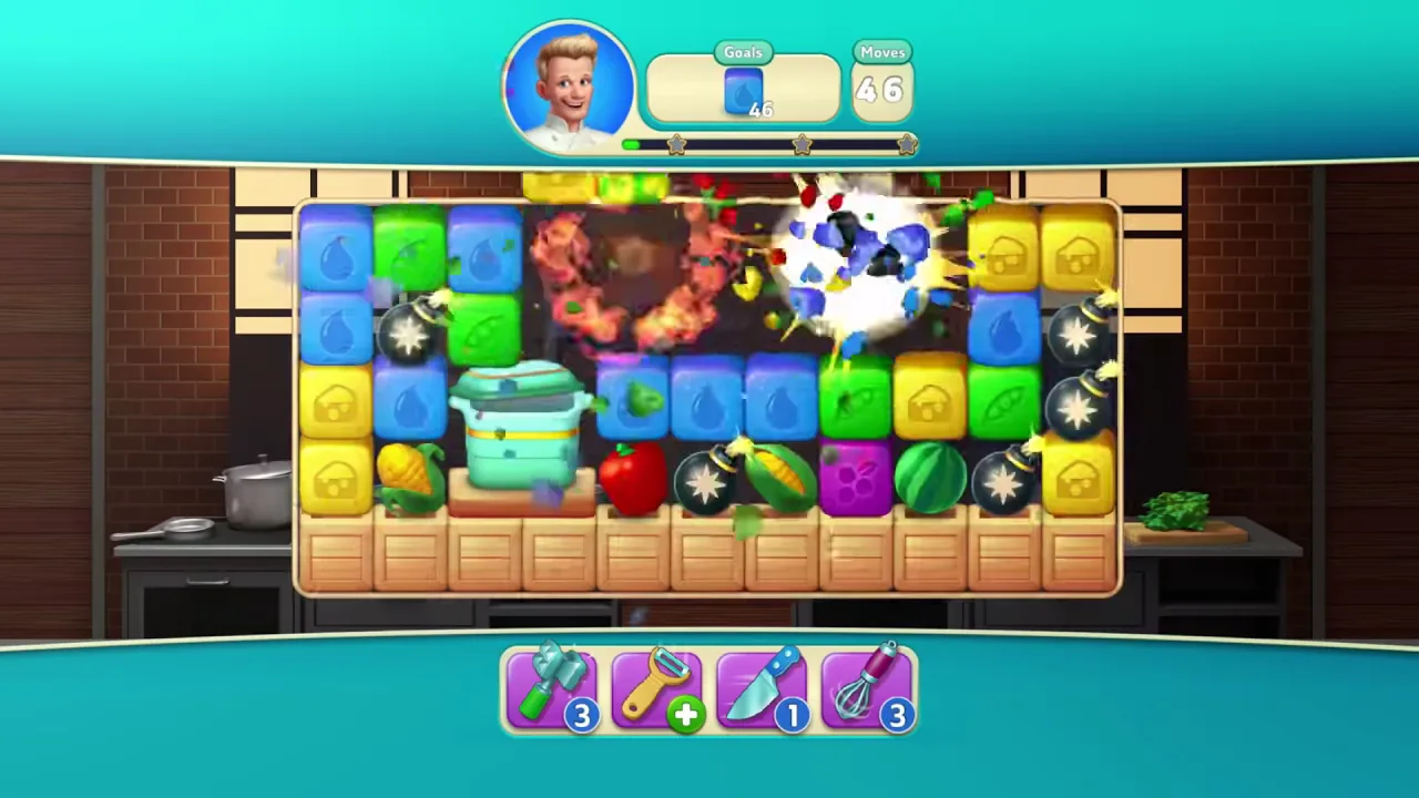 Gameplay from Gordon Ramsay's Chef Blast, showing a match-3 board of coloured blocks mid-explosion in a kitchen.
